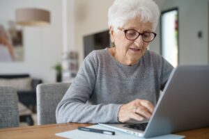 Senior on Computer interacting with others