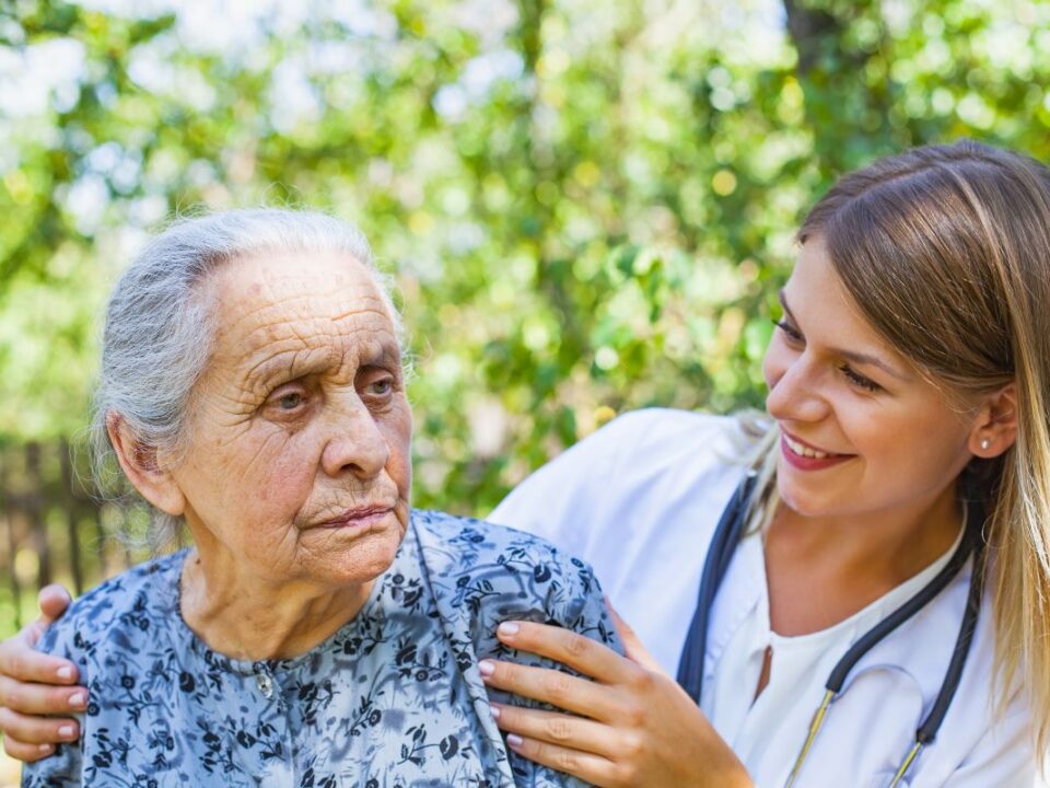 Elderly lady being taken care of by a caregiver