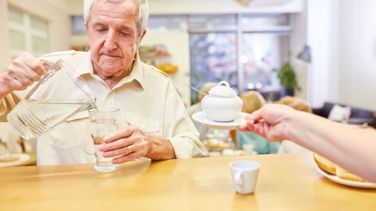 Elderly Gentleman Being Served Tea at Home