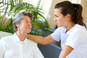In-home aide assisting patient recovering