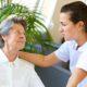 In-home aide assisting patient recovering