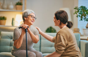 Caregiver assisting senior in home